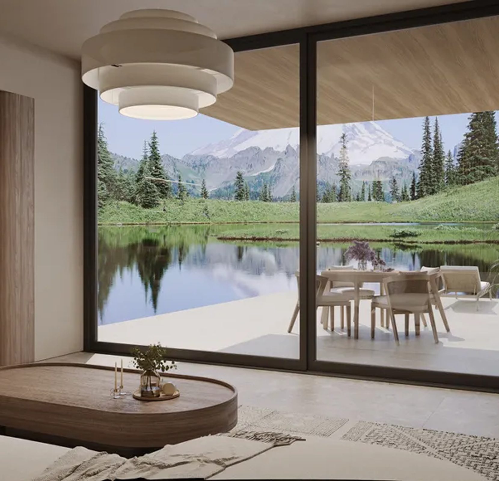 Modern living room with a large window overlooking a scenic landscape of trees, a pond, and mountains. A patio with a table and chairs is visible outside. A round coffee table is in the foreground.