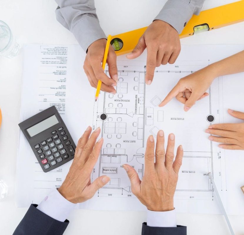 A group of people sitting at a table with some papers
