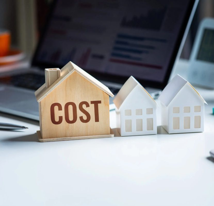 A wooden house with the word " cost " on it.